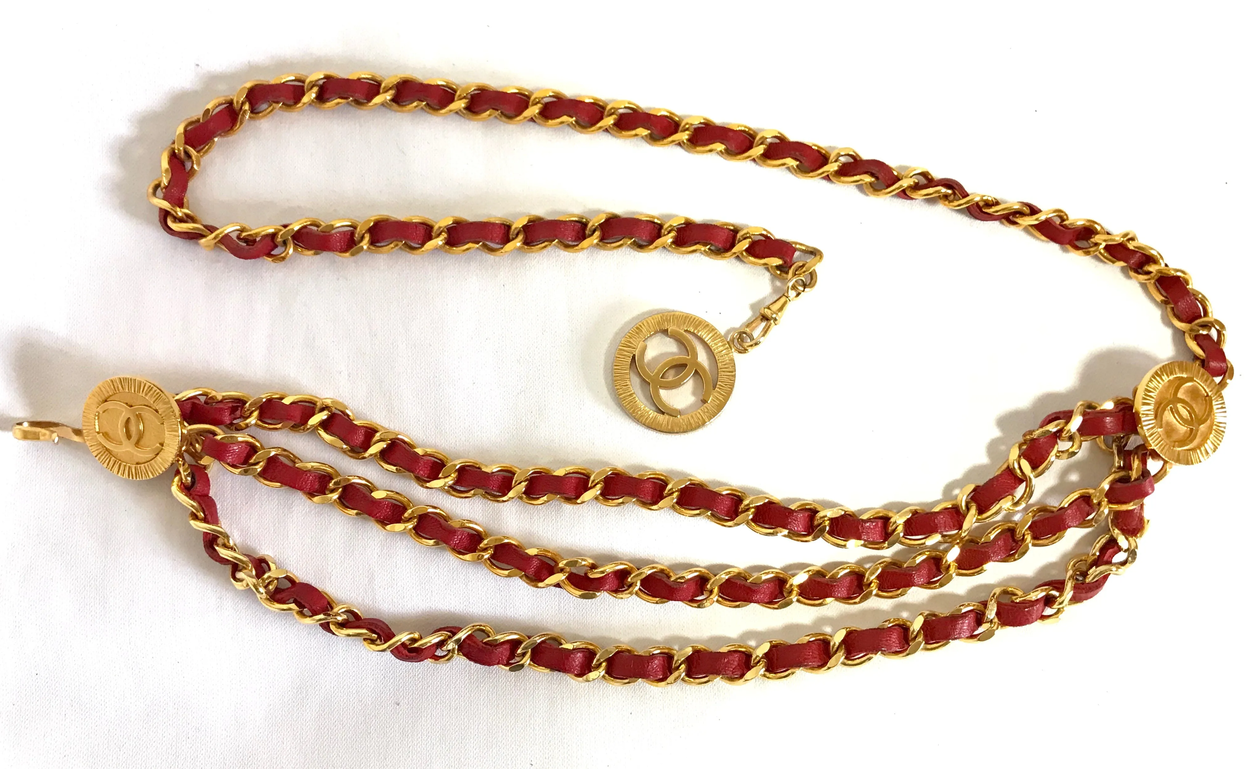 80's Vintage CHANEL red leather and chain belt with golden CC charms. Must-have belt from CHANEL. Triple layer belt.