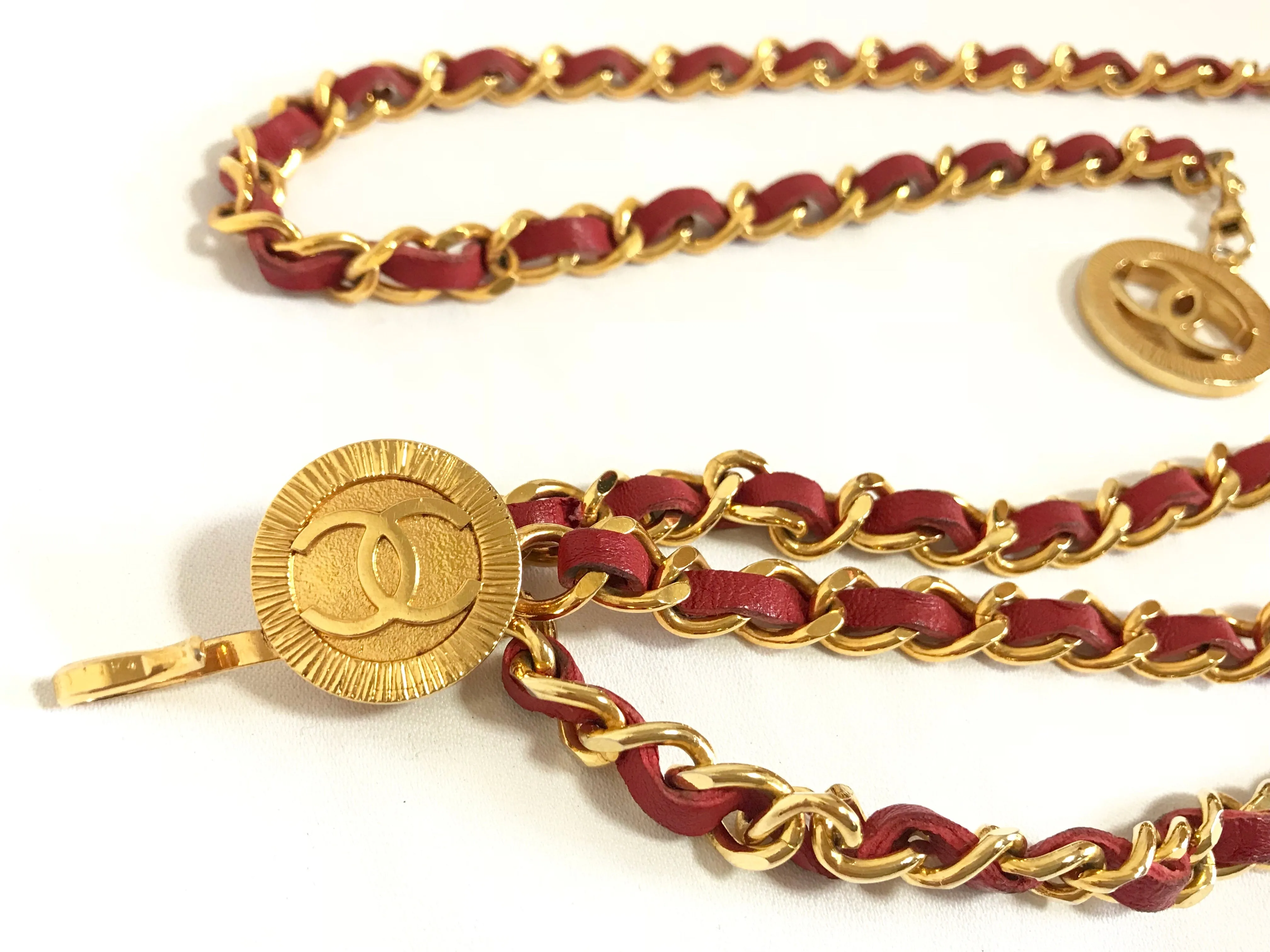 80's Vintage CHANEL red leather and chain belt with golden CC charms. Must-have belt from CHANEL. Triple layer belt.