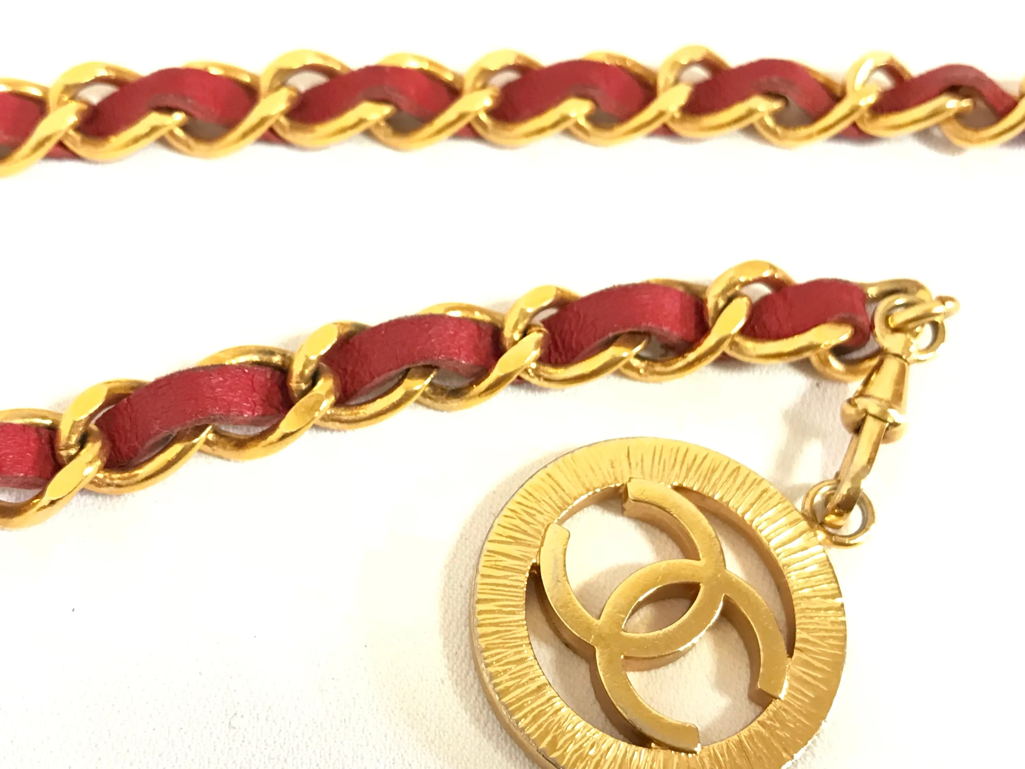 80's Vintage CHANEL red leather and chain belt with golden CC charms. Must-have belt from CHANEL. Triple layer belt.