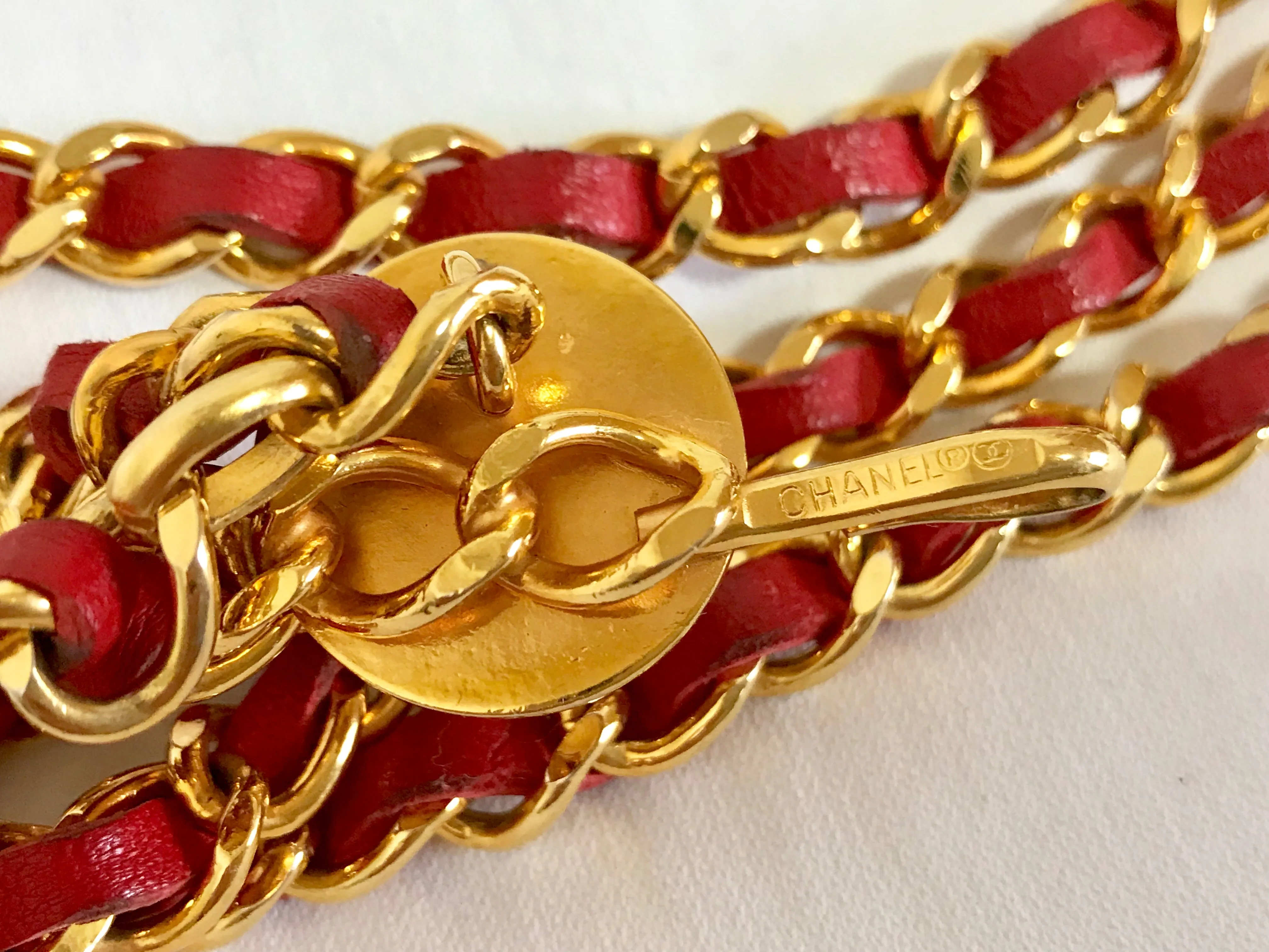 80's Vintage CHANEL red leather and chain belt with golden CC charms. Must-have belt from CHANEL. Triple layer belt.
