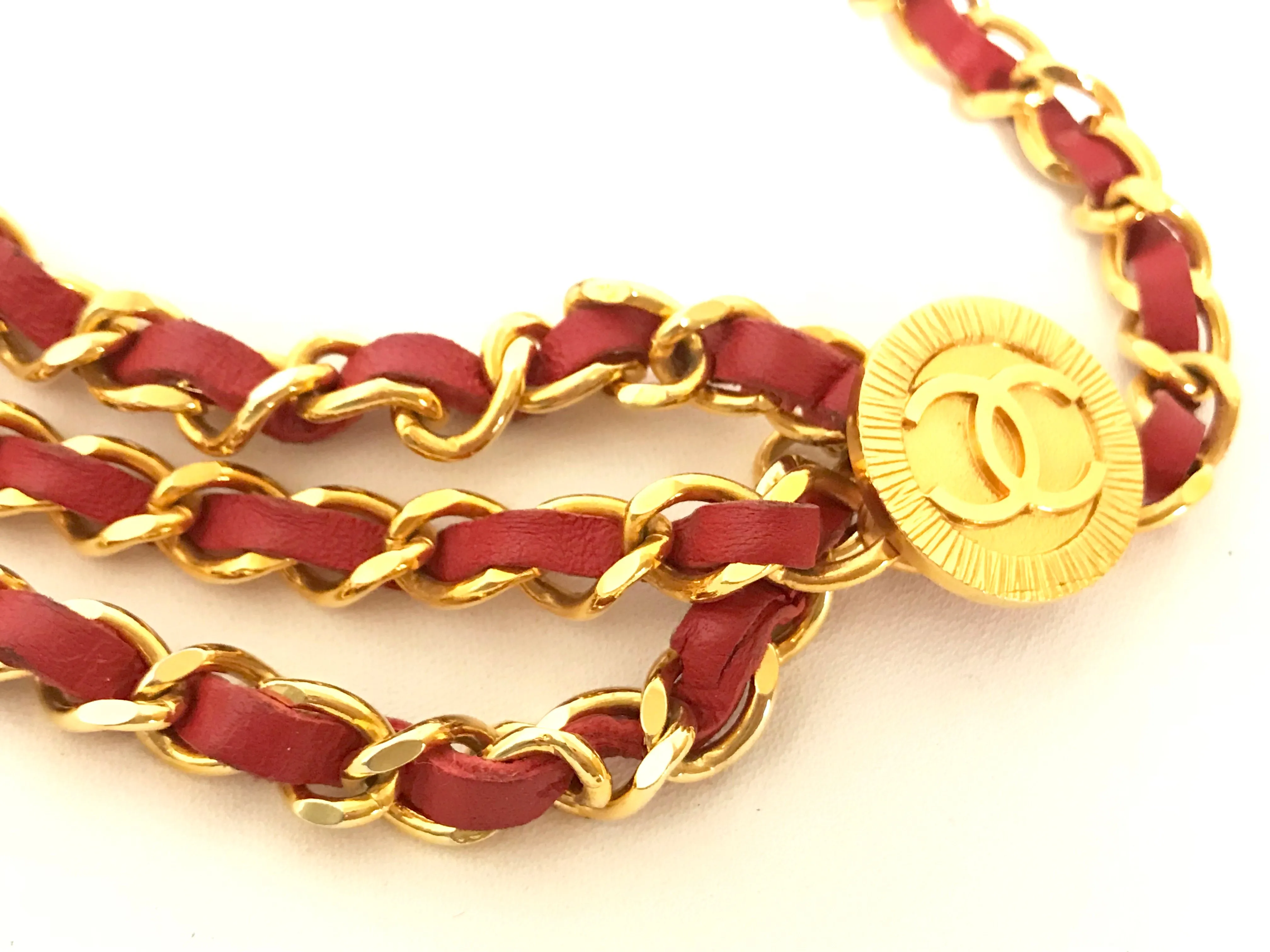 80's Vintage CHANEL red leather and chain belt with golden CC charms. Must-have belt from CHANEL. Triple layer belt.